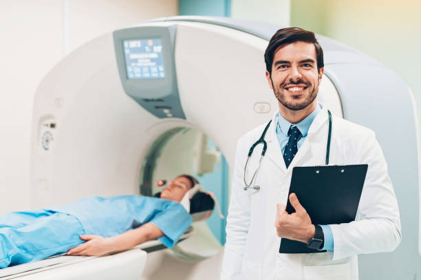 istock Smiling doctor holding a clipboard in the diagnostic room 1130570010