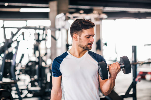 istock Determined young man working out in gym. 1130570755
