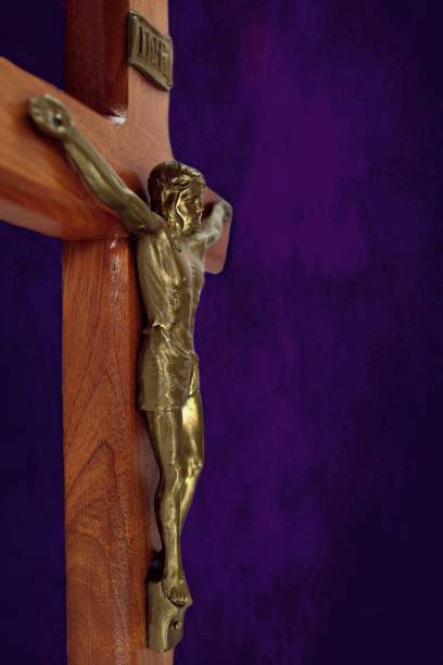istock Crucifix on mottled purple and black shades 1130570970
