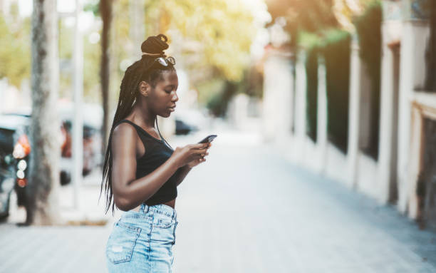 istock Black girl outdoors with cell phone 1130572867