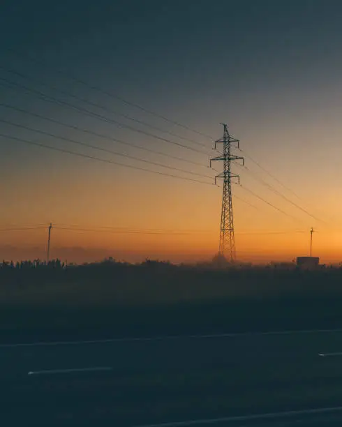 Photo of Power line support during sunrise