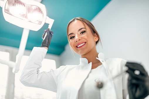 Portrait of a smiling dentist from the perspective of a patient.