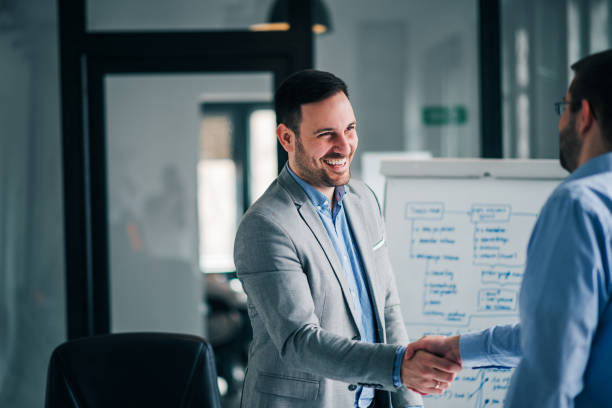 istock Cheerful businessman shaking hands with business partner. 1130573193