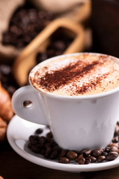 istock coffee cup close-up over dark roasted coffee beans 1130573907