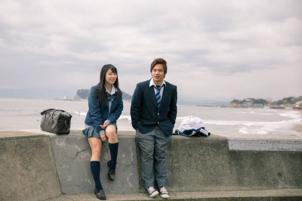 High school student couple dating at seaside