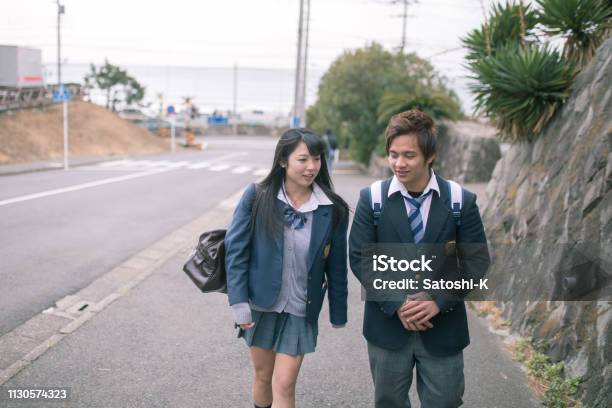 High School Student Couple Going To Scholl Stock Photo - Download Image Now - Couple - Relationship, Talking, Dating