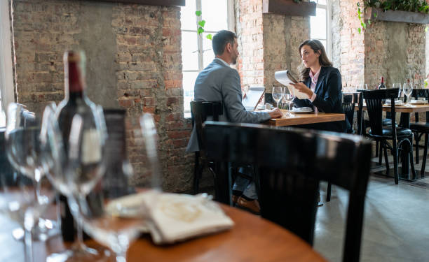 istock Latin american couple on a date talking seriously while holding the menu 1130576081