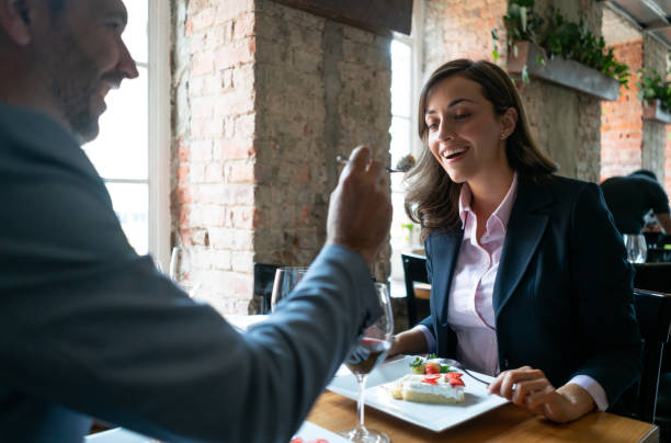 istock Loving man feeding girlfriend on a date at a restaurant 1130576108