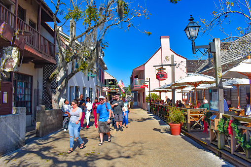 St. Augustine, Florida. January 26 , 2019 . People enjoying colonial experience in St. George St. on blue sky background in Old Town at Florida's Historic Coast  (1)