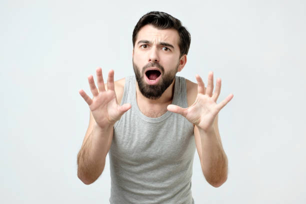 istock Young man is afraid and terrified with fear expression stop gesture with hands 1130578908