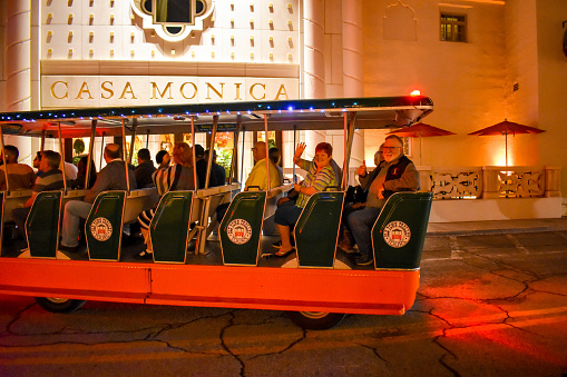 St. Augustine, Florida. January 26 , 2019 . Trolley tour at night on Casa Monica Hotel background in Florida's Historic Coast.