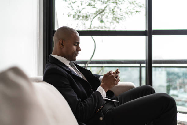 istock Afro businessman smiling sitting on the sofa 1130579079