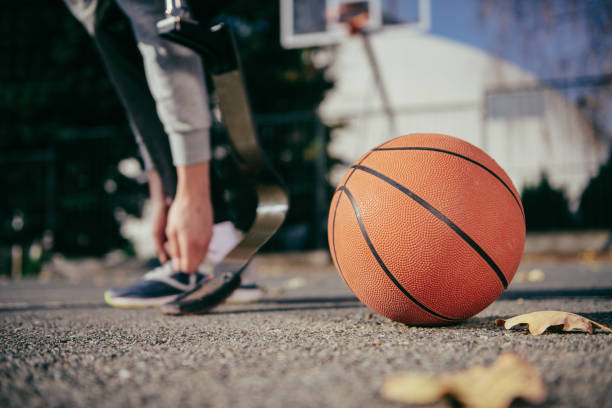 istock Young man with artificial limb on a basketball court 1130579915