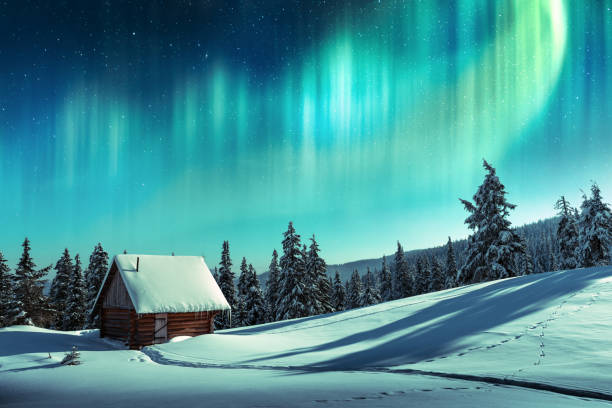 Fantastic landscape with orthen light Fantastic winter landscape with wooden house in snowy mountains and northen light in night sky hut stock pictures, royalty-free photos & images
