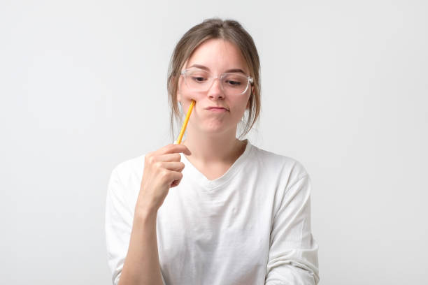 istock irl is thinking about exams holding pencil 1130581474