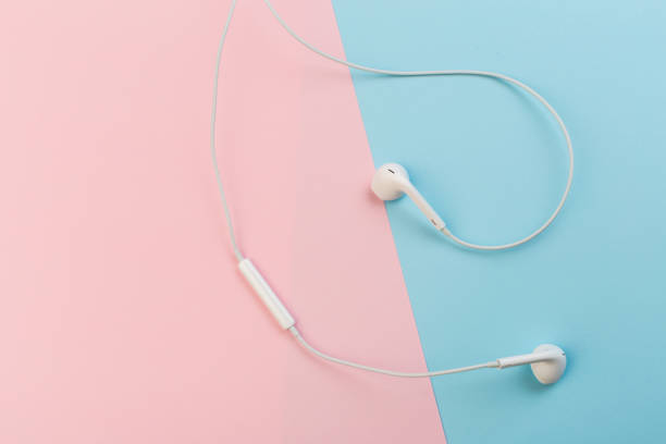 istock white earphones on pink and blue background 1130584173