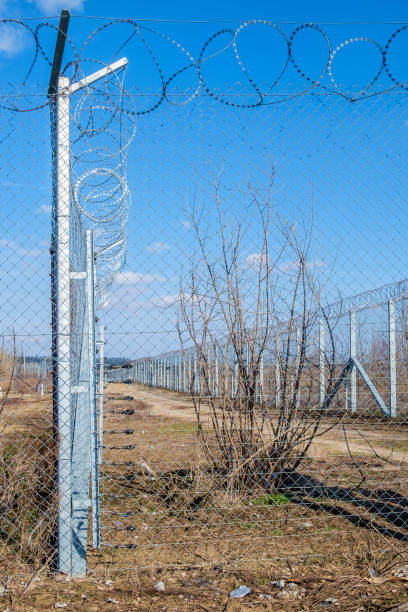 istock safety fence, high and metallic, mesh with blades 1130584272