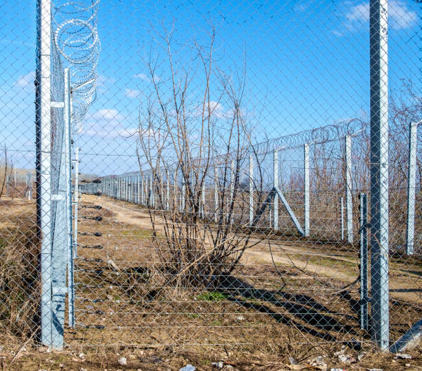 istock safety fence, high and metallic, mesh with blades 1130585496