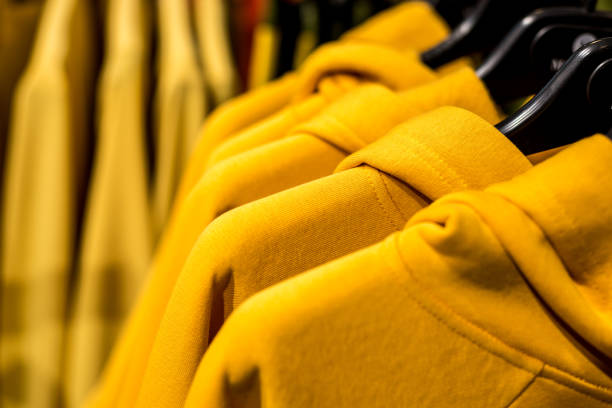 istock Yellow clothes hanging on store racks 1130588920