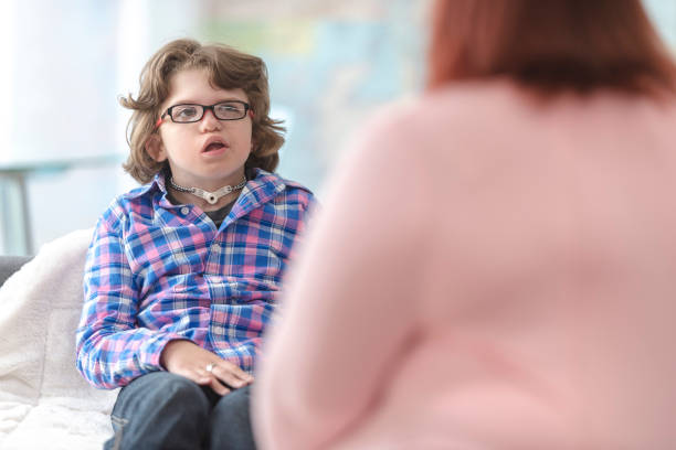 istock Young kid sitting with his speech therapist 1130592153