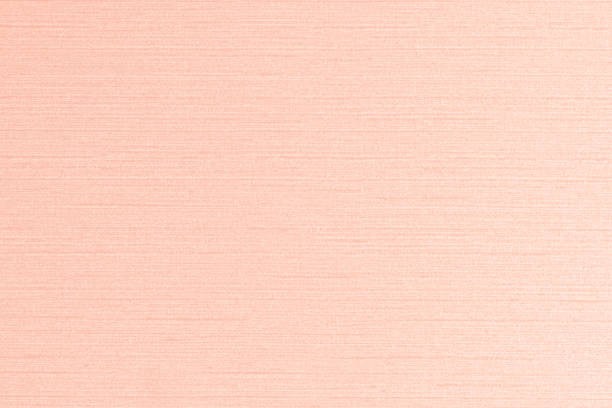 istock Blended cotton silk fabric textile wallpaper detailed texture pattern background in sweet light bright pink orange cream color 1130592221