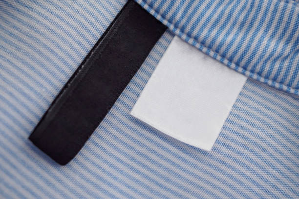 istock blank black and white clothing label on blue fabric texture background 1130592468