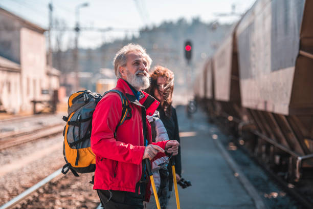 istock Mature man waiting for a train at railway station on a sunny day. 1130597973