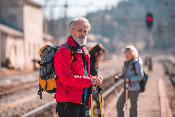 istock Mature man waiting for a train at railway station on a sunny day. 1130597997