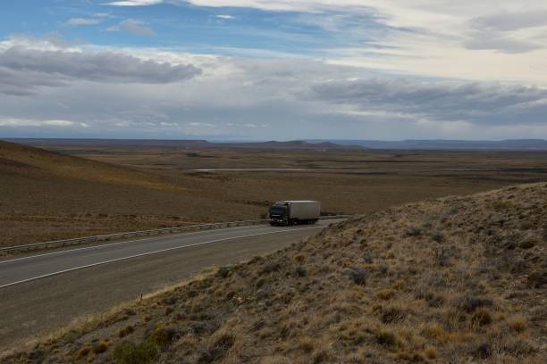 istock dark truck going up with cloudy sky background 1130601645