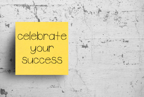 istock Sticky note on concrete wall, Celebrate Your Success 1130603253