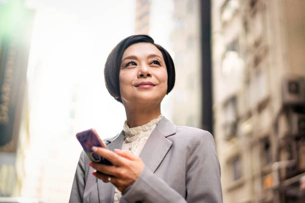 Successful Asian businesswoman Smiling Chinese businesswoman in Hong Kong. chinese woman stock pictures, royalty-free photos & images