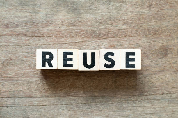 istock Letter block in word reuse on wood background 1130607310