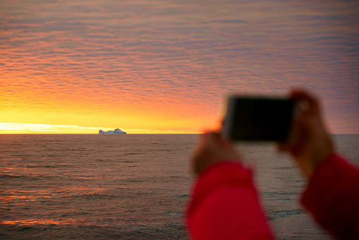 Women take pictures on an Antarctic ship