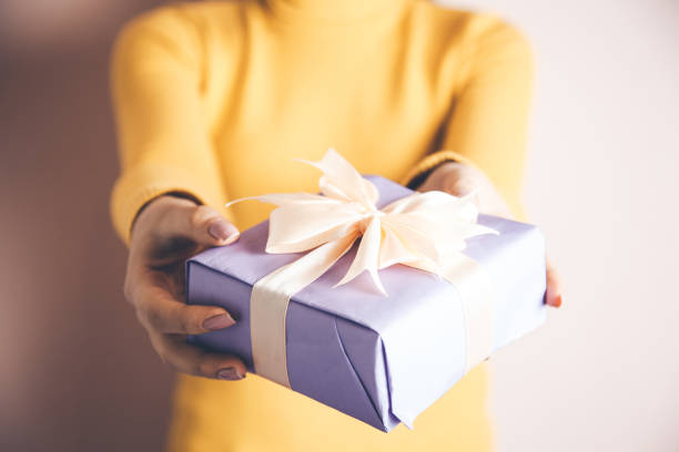 istock woman hand gift box 1130614249