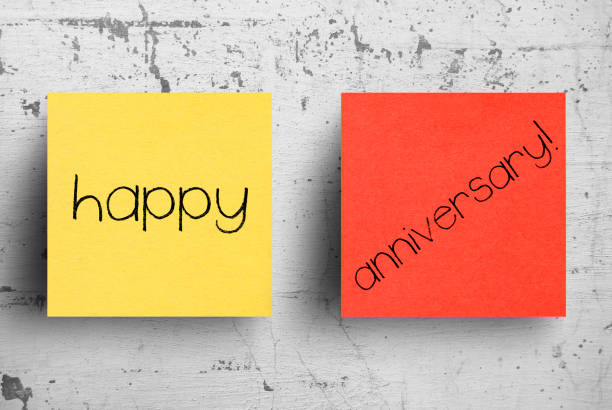 istock Sticky note on concrete wall, Happy Anniversary 1130614255