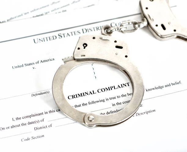 istock Criminal Complaint Court Papers with Handcuffs 1130615616