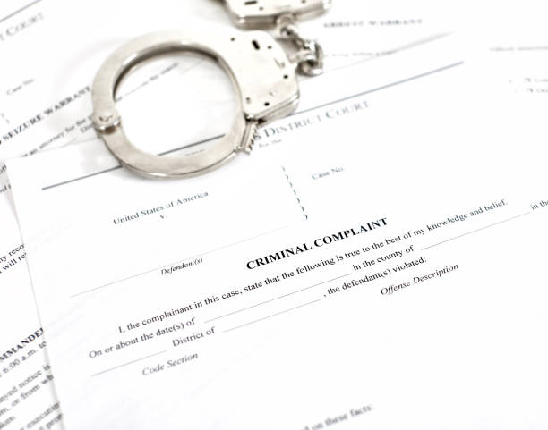 Criminal Complaint Court Papers with Handcuffs stock photo