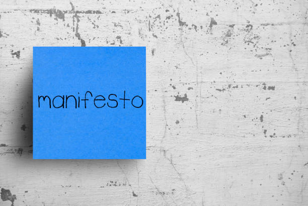 istock Sticky note on concrete wall, Manifesto 1130619788