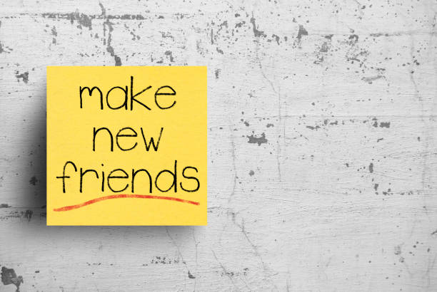 istock Sticky note on concrete wall, Make new friends 1130620580