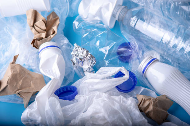 istock Unsorted clean garbage in a pile. Bottles, bags and paper on blue background. Environmental pollution and waste sorting 1130620753