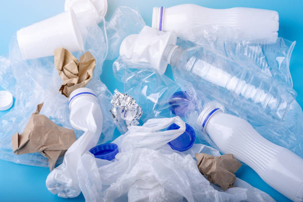 istock Unsorted clean garbage in a pile. Bottles, bags and paper on blue background. Environmental pollution and waste sorting 1130620759