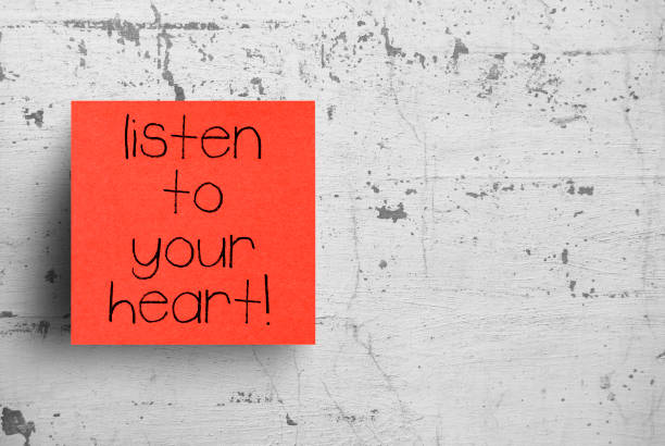 istock Sticky note on concrete wall, Listen to your heart 1130621401