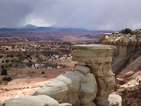 Colorful canyon walls of the Salt Wash Overlook of the San Rafael Swell in Utah. Sandstone rock formations are in the foreground.