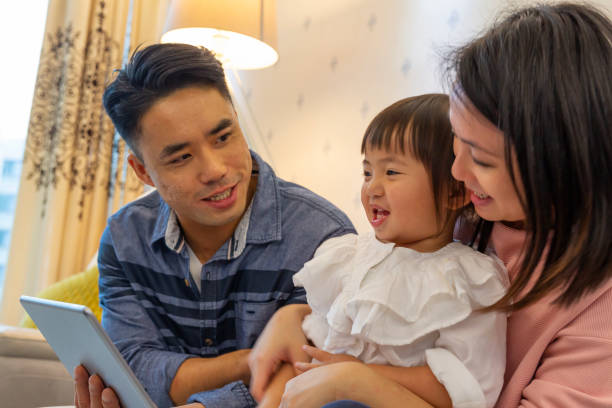 istock Asian Parents Reading to their Daughter With a Tablet Computer 1130622415
