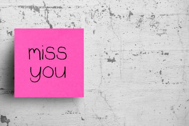 istock Sticky note on concrete wall, Miss you 1130623221