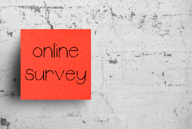 istock Sticky note on concrete wall, Online Survey 1130623417