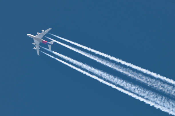 istock Airplane In Blue Sky With Plane Trails 1130625188