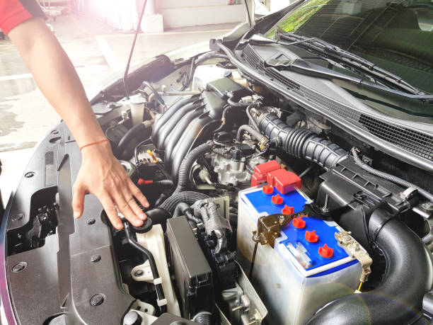 istock Mechanic with scan tool diagnosing car in open hood. Checking car engine before driving to travel, Soft focus 1130626444