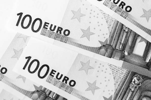 istock One Hundred euro banknotes as a background close up. Black and white 1130627246