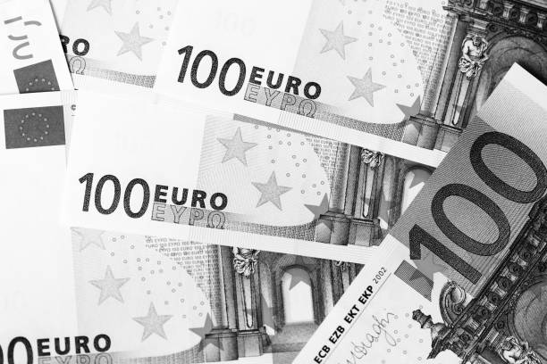 istock One Hundred euro banknotes as a background close up. Black and white 1130627248
